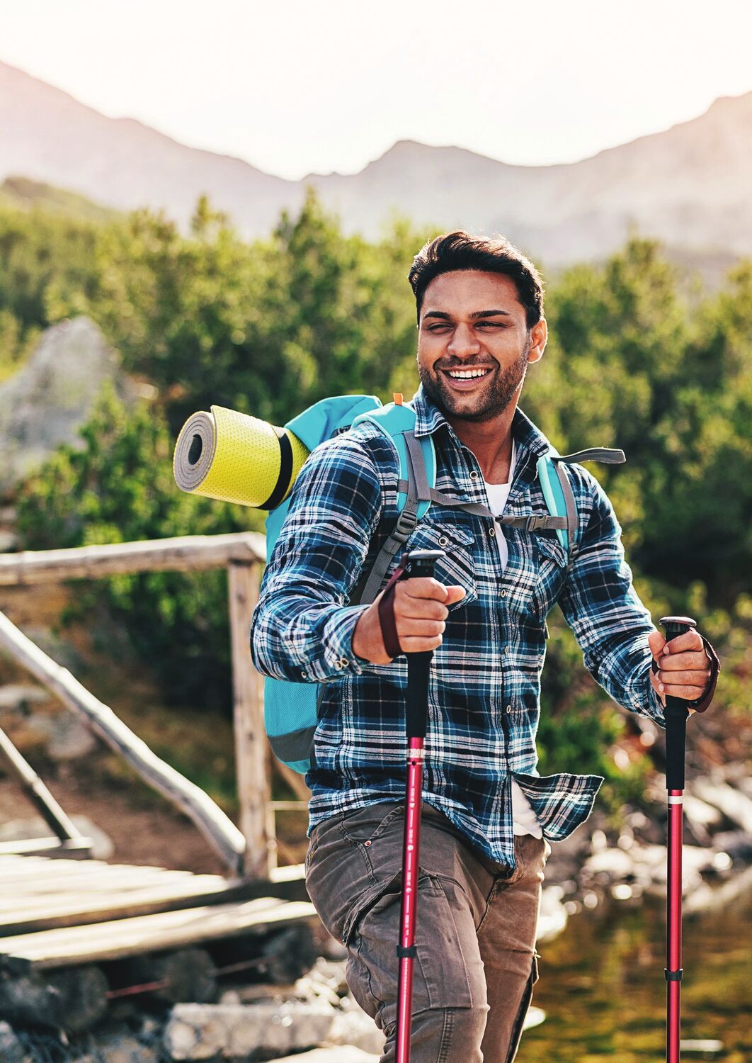 An entrepreneur pausing on a mountain road at sunrise